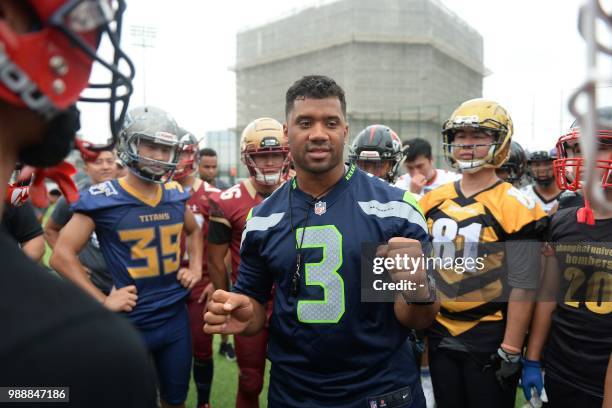 Football quarterback Russell Wilson takes part in a training session at a football camp in Shanghai on July 1, 2018. / China OUT