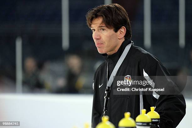 National coach Uwe Krupp of Germany looks thoughtful during a training session at the Veltins Arena ahead of the IIHF World Championship on May 6,...