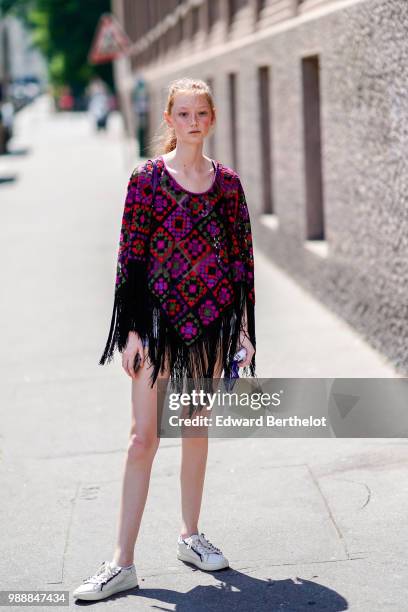 Model wears a purple top with printed checked patterns and black fringes, outside Acne Studios, during Paris Fashion Week - Womenswear Fall Winter...