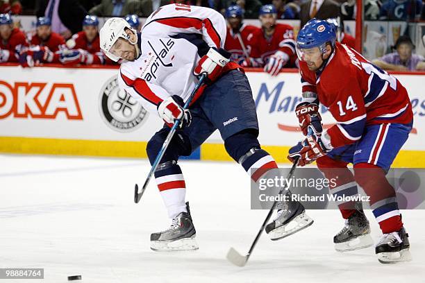 Eric Fehr of the Washington Capitals passes the puck while being defended by Tomas Plekanec of the Montreal Canadiens in Game Six of the Eastern...