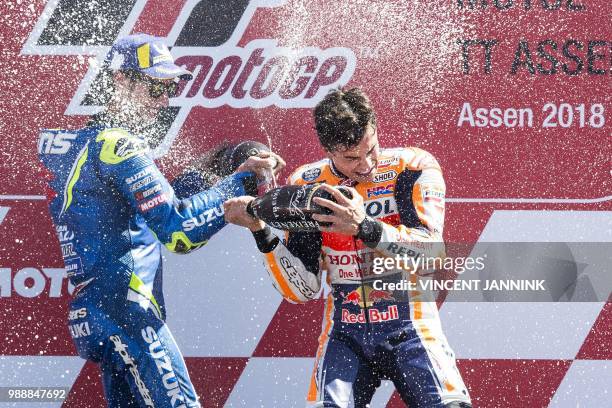 Winner Marc Marquez from Spain and second placed Alex Rins from Spain celebrate on the podium during the MotoGP race of the Motorcycling Grand Prix...