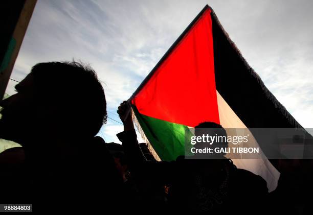Palestinian, foreign and Israeli left-wing activists take part in a protest in the mostly Arab Jerusalem neighborhood of Sheikh Jarrah on January 22,...