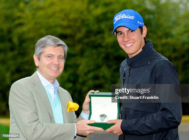 Matteo Manassero of Italy is presented with a Rolex watch by Gianpaolo Marini of Rolex after the first round of the BMW Italian Open at Royal Park I...