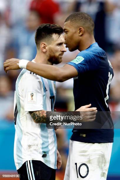 Lionel Messi of Argentina and Kylian Mbappe of France embrace after the 2018 FIFA World Cup Russia Round of 16 match between France and Argentina at...