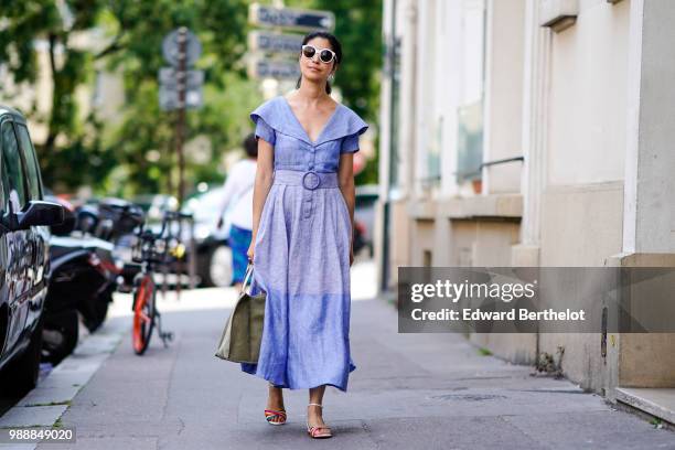 Caroline Issa wears sunglasses, a blue dress , outside Acne Studios, during Paris Fashion Week - Womenswear Fall Winter 2019, on July 1, 2018 in...