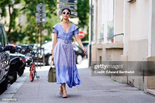 Caroline Issa wears sunglasses, a blue dress , outside Acne Studios, during Paris Fashion Week - Womenswear Fall Winter 2019, on July 1, 2018 in...