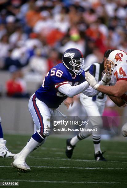 S: Linebacker Lawrence Taylor of the New York Giants is blocked by offensive tackle Paul Gruber of the Tampa Bay Buccaneers circa late 1980's during...