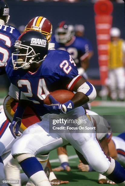 S: Running back Otis Anderson of the New York Giants carries the ball against the Washington Redskins circa late 1980's during an NFL football game...