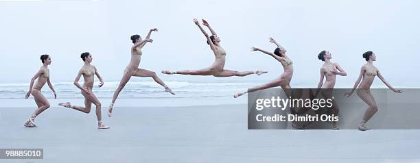 ballerina leaping through air on beach - continuity imagens e fotografias de stock