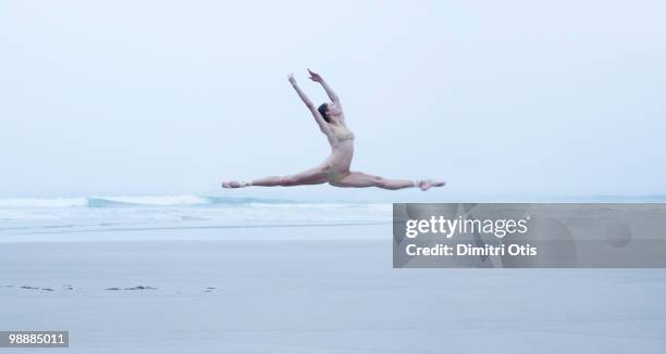 ballerina leaping on the beach - spagat frau stock-fotos und bilder