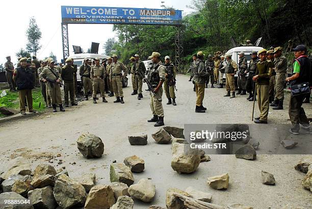 Indian security forces stand guard at the Mao Gate Bazar just after a crowd waiting to welcome a separatist leader was dispersed at the...