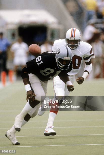 Cornerback Mike Haynes of the New England Patriots guarding wide receiver Morris Bradshaw of the Oakland Raiders November 1, 1981 during an NFL...