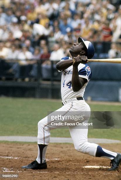 Outfielder Hank Aaron of the Atlanta Braves swings and pops the ball up on the infield circa 1974 during a Major League Baseball game at...
