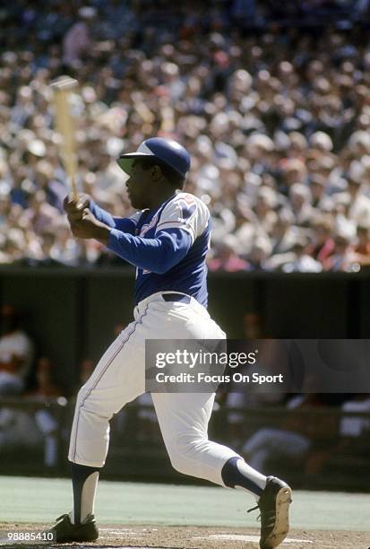 Outfielder Hank Aaron of the Atlanta Braves swings and watches the flight of his ball against the Cincinnati Reds circa 1974 during a Major League...