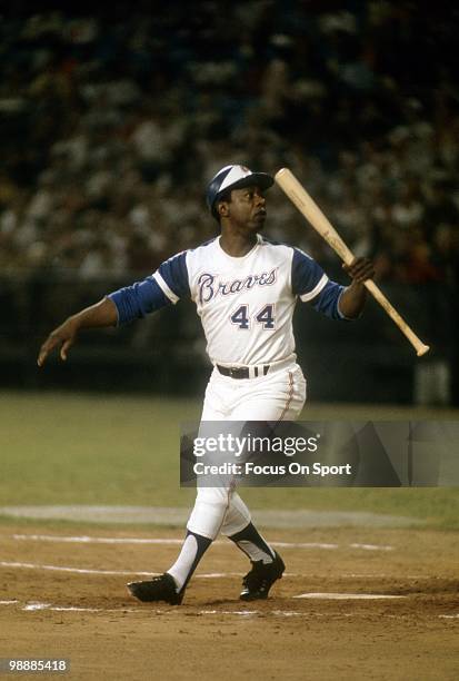 Outfielder Hank Aaron of the Atlanta Braves looks back at a foul ball circa 1974 during a Major League Baseball game at Atlanta-Fulton County Stadium...