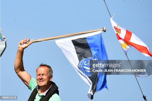 Estonian's Uku Randmaa gestures on his boat "Rustler 36" as he sets sail from Les Sables d'Olonne Harbour on July 1 at the start of the solo...