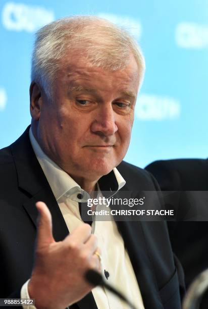 German Interior Minister and Bavarian Christian Social Union politician Horst Seehofer gestures at the beginning of a party leadership meeting of the...