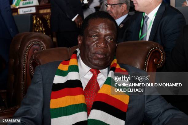 Zimababwean President Emmerson Mnangagwa sits with delegates as he attends the plenary session of the 31st Ordinary Session of the Assembly of...