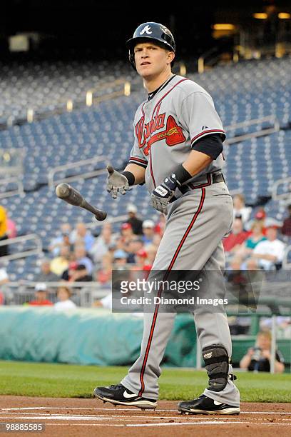 Outfielder Nate McLouth of the Atlanta Braves tosses the bat away as he draws a base on balls to lead off the top of the first inning of a game on...
