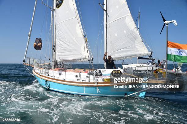 India's Abhilash Tomy gestures on his boat "Thuriya" as he sets off from Les Sables d'Olonne Harbour on July 1 at the start of the solo...