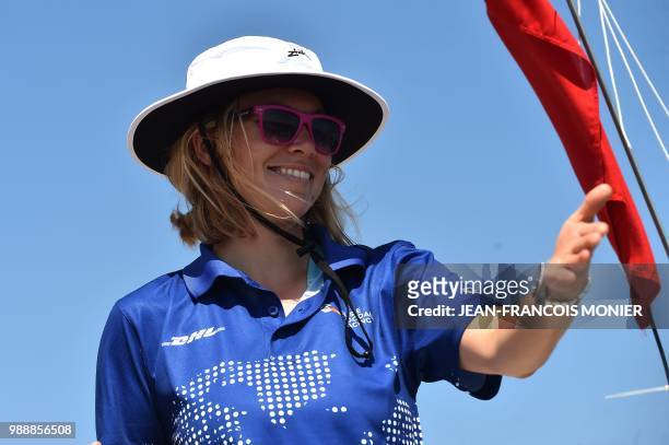 Britain's Susie Goodall gestures on her boat "DHL Starlight" as she sets sail from Les Sables d'Olonne Harbour on July 1 at the start of the solo...