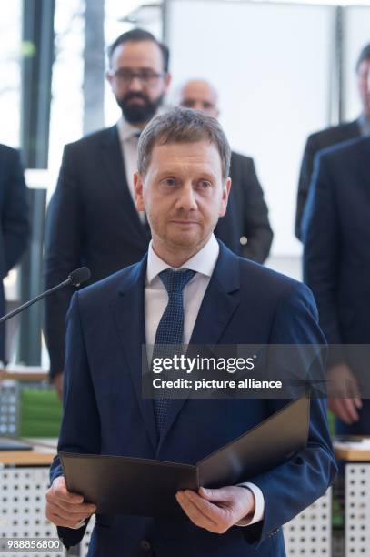 The new Prime Minister of Saxony, Michael Kretschmer , takes the oath of office during the meeting of the state parliament in Dresden, Germany, 13...