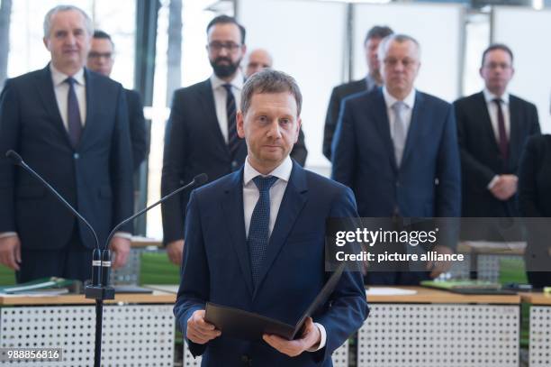 The new Prime Minister of Saxony, Michael Kretschmer , takes the oath of office during the meeting of the state parliament in Dresden, Germany, 13...