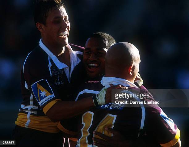 Scott Prince, Lote Tuqiri and Corey Parker of Brisbane celebrate scoring a try against the Cowboys during the round 14 NRL match between the Brisbane...