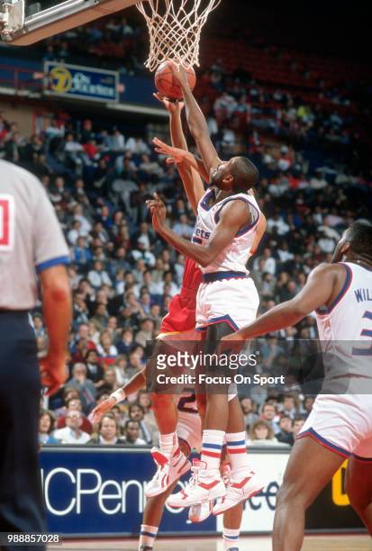 Darrell Walker of the Washington Bullets blocks the shot of Doc Rivers of the Atlanta Hawks during an NBA basketball game circa 1989 at the Capital...