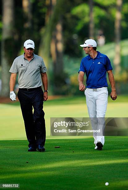 Phil Mickelson and Dustin Johnson walk up the tenth fairway during the first round of THE PLAYERS Championship held at THE PLAYERS Stadium course at...