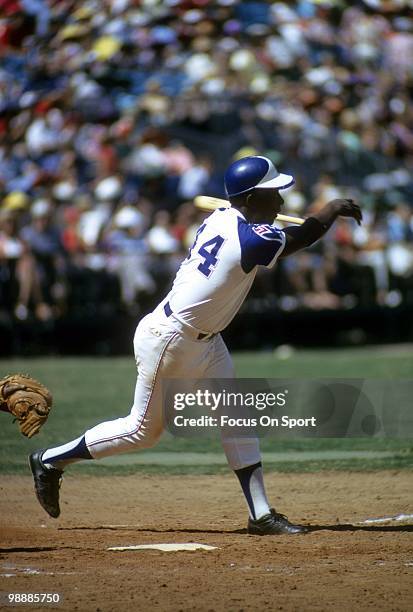 Outfielder Hank Aaron of the Atlanta Braves swings and misses the pitch circa 1974 during a Major League Baseball game at Atlanta-Fulton County...