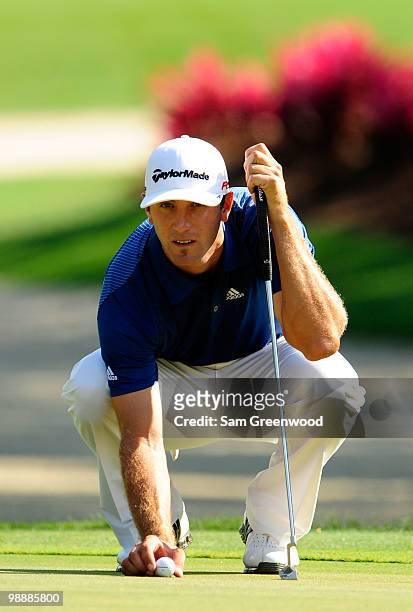 Dustin Johnson lines up a putt on the 14th green during the first round of THE PLAYERS Championship held at THE PLAYERS Stadium course at TPC...
