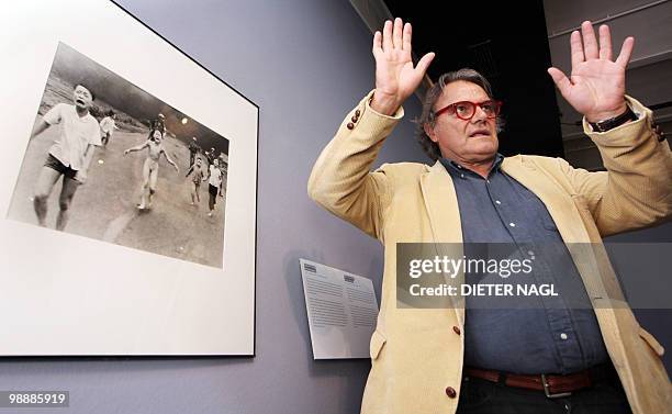 Italian Photographer Oliviero Toscani gestures in front of a photo taken during the Vietnam war, at an exhibition entitled "controversy, justice,...