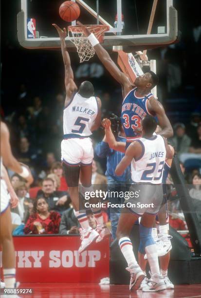 Darrell Walker of the Washington Bullets shoots over Patrick Ewing of the New York Knicks during an NBA basketball game circa 1991 at the Capital...