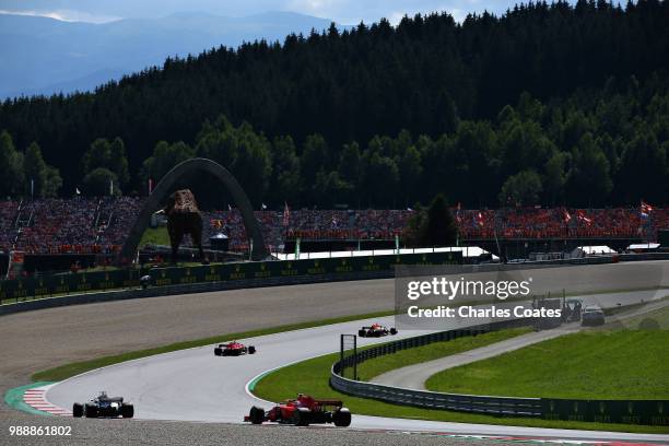 Daniel Ricciardo of Australia driving the Aston Martin Red Bull Racing RB14 TAG Heuer leads Kimi Raikkonen of Finland driving the Scuderia Ferrari...