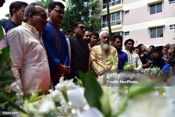 People offer tribute in front of the building once housed the Holey Artisan Bakery, on the second anniversary of the deadly hostage crisis at the...