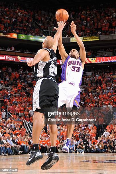 Grant Hill of the Phoenix Suns shoots against Richard Jefferson of the San Antonio Spurs in Game One of the Western Conference Semifinals during the...