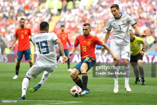 Jordi Alba of Spain is challenged by Alexander Samedov of Russia and Daler Kuziaev of Russia during the 2018 FIFA World Cup Russia Round of 16 match...