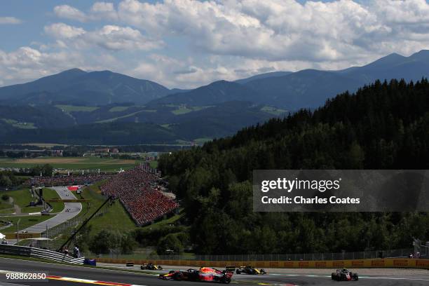 Daniel Ricciardo of Australia driving the Aston Martin Red Bull Racing RB14 TAG Heuer leads Kevin Magnussen of Denmark driving the Haas F1 Team VF-18...