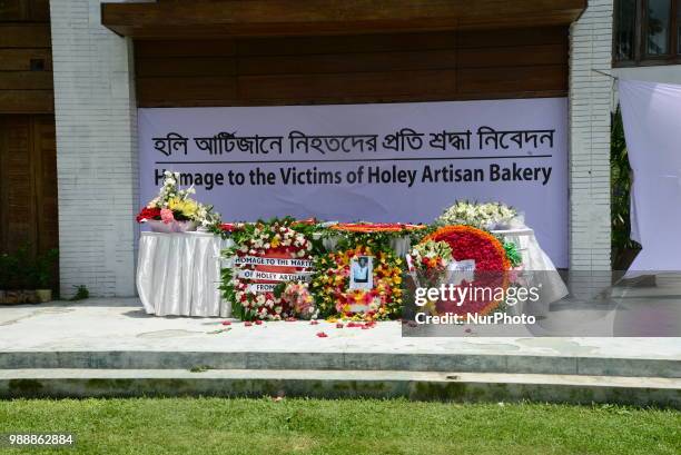 People offer tribute in front of the building once housed the Holey Artisan Bakery, on the second anniversary of the deadly hostage crisis at the...