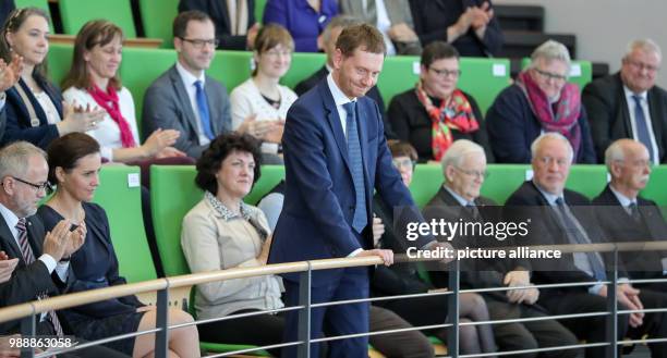 The new Prime Minister of Saxony, Michael Kretschmer , reacts to his election next to his partner Annett Hofmann during the meeting of the state...