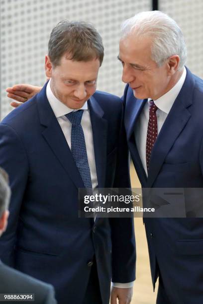 Former Saxonian Prime Minister Stanislaw Tillich congratulates the new Prime Minister of Saxony, Michael Kretschmer during the meeting of the state...