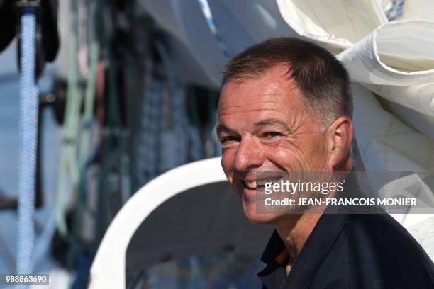 Finnish skipper Tapio Lehtinen smiles on his boat "Asteria" as he sets off in Les Sables d'Olonne Harbour on July 1 at the start of the solo...