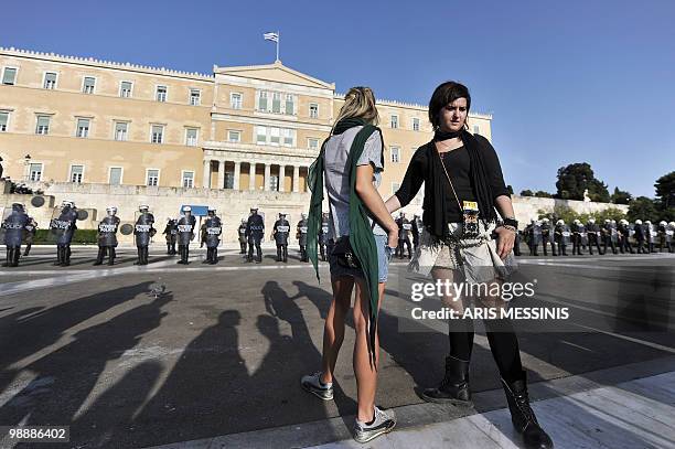 Protestors look at a police cordon in front of the Greek Parliament in the center of Athens on May 6, 2010. More than 10,000 people demonstrated...