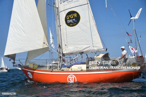 Hungarian born and US Istvan Kopar on his boat "Puffin" competes from Les Sables d'Olonne Harbour on July 1 at the start of the solo around-the-world...