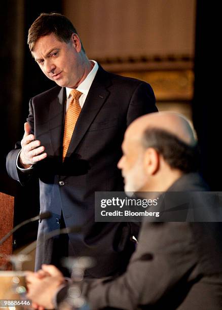 Charles Evans, president of the Federal Reserve Bank of Chicago, left, introduces Ben S. Bernanke, chairman of the U.S. Federal Reserve, at the...