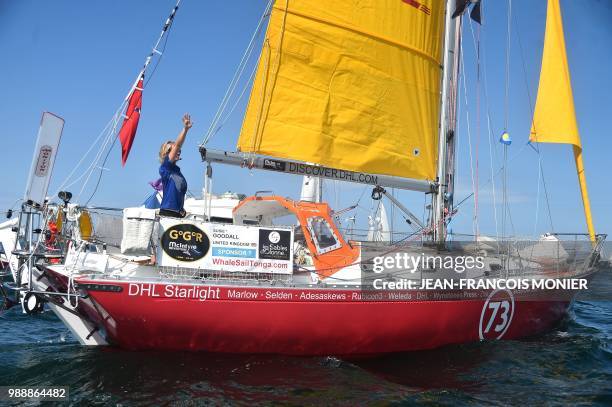 Britain's Susie Goodall waves from her boat "DHL Starlight" as she set off from Les Sables d'Olonne Harbour on July 1 at the start of the solo...