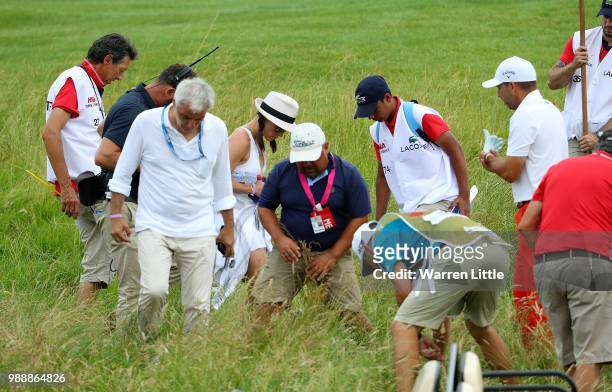 Angela Garcia, wife of Sergio Garcia helps to look for her husbands ball on the 9th hole during day four of the HNA Open de France at Le Golf...