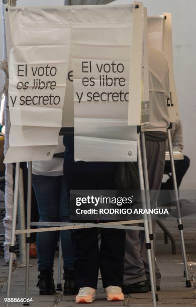 An elderly man casts his vote during general elections, in Queretaro on July 1, 2018. - Fed up with corruption and violence, Mexicans will elect...