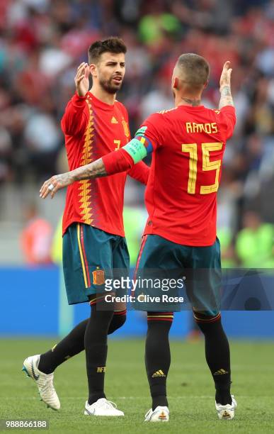 Sergio Ramos and Gerard Pique of Spain celebrate after Sergey Ignashevich of Russia scores an own goal for Spain's first goal during the 2018 FIFA...